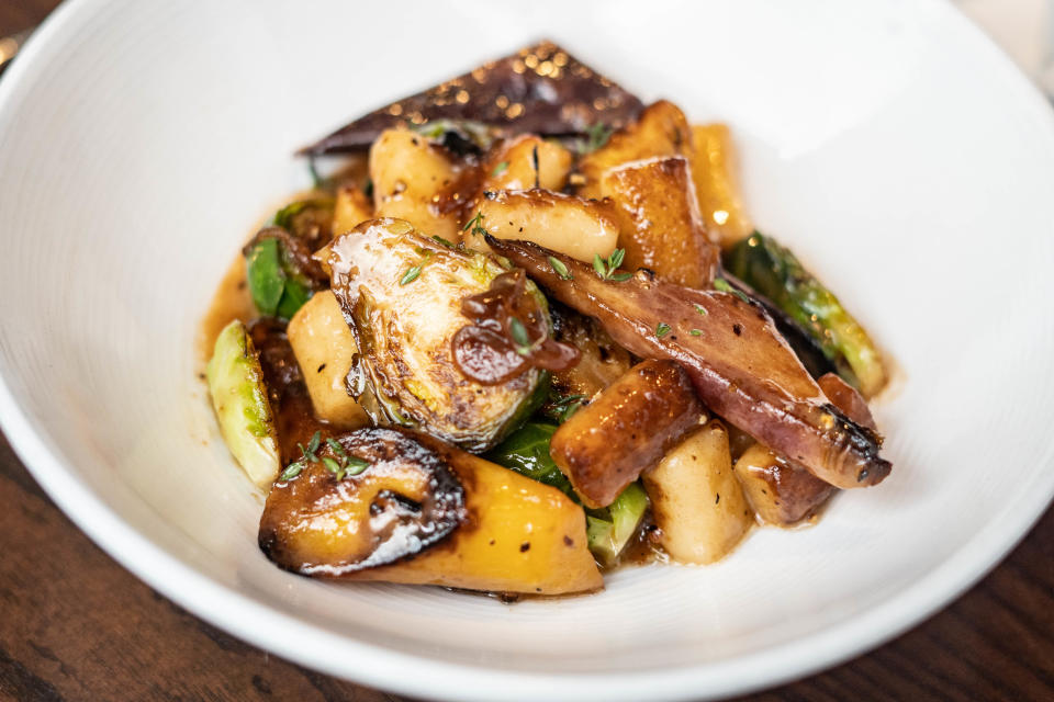 Posana's ricotta gnocchi with roasted rainbow carrots, brussels sprouts, cipollini onion, wine, butter, and thyme.