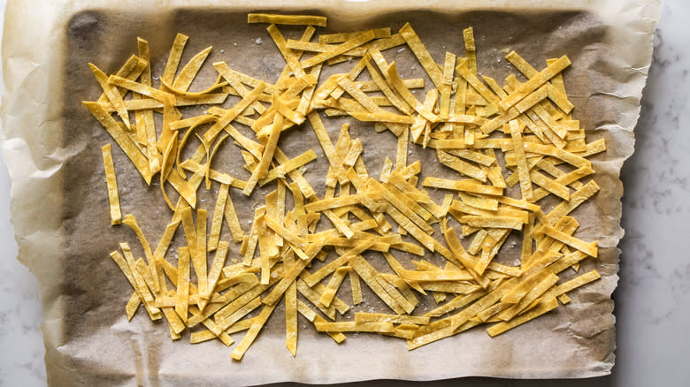 unbaked tortilla strips on pan