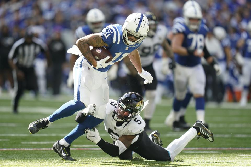 Indianapolis Colts' Michael Pittman Jr. (11) is tackled by Jacksonville Jaguars' Andre Cisco (5) during the second half of an NFL football game, Sunday, Oct. 16, 2022, in Indianapolis.(AP Photo/Michael Conroy)