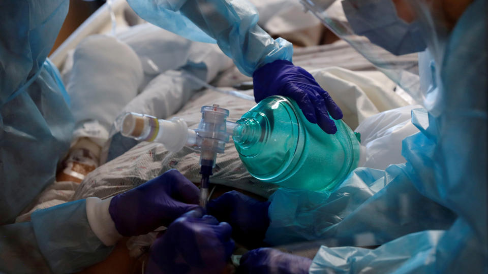 Critical care workers insert an endotracheal tube into a coronavirus disease (COVID-19) positive patient in the intensive care unit (ICU) at Sarasota Memorial Hospital in Sarasota, Florida, February 11, 2021. (Shannon Stapleton/Reuters)