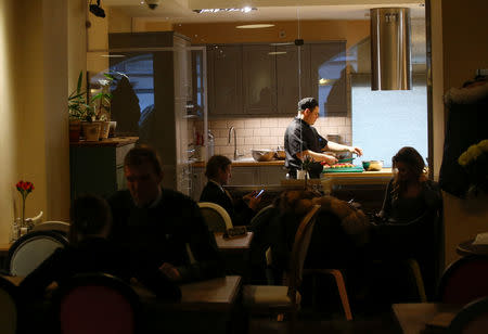 FILE PHOTO: A chef of Caffe Italia restaurant cooks soup as part of a charity program to help homeless people in St. Petersburg, Russia November 28, 2018. REUTERS/Anton Vaganov