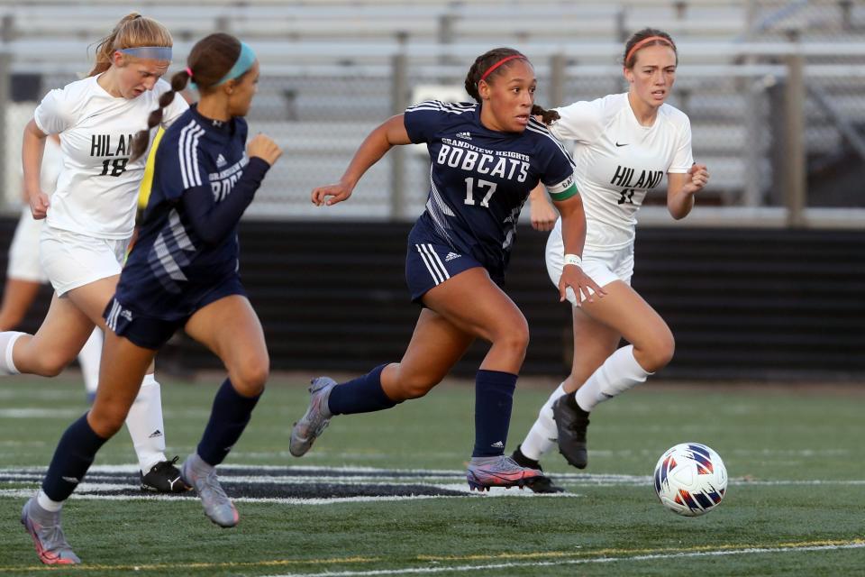 Grandview Heights' Natalie Smith pushes the ball down field past Berlin Hiland's Kaitlyn Miller (18) and Lydia Weaver (11) during an OHSAA Division III Girls Soccer Regional Semifinal game Nov. 1 at Westerville Central High School.