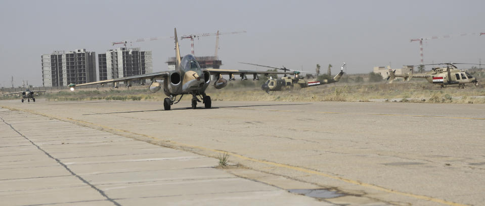 Russian Sukhoi Su-25 fighter planes land as they arrive at Iraq's al-Muthanna military airbase at Baghdad airport, in Baghdad, July 1, 2014. I(REUTERS/Stringer)