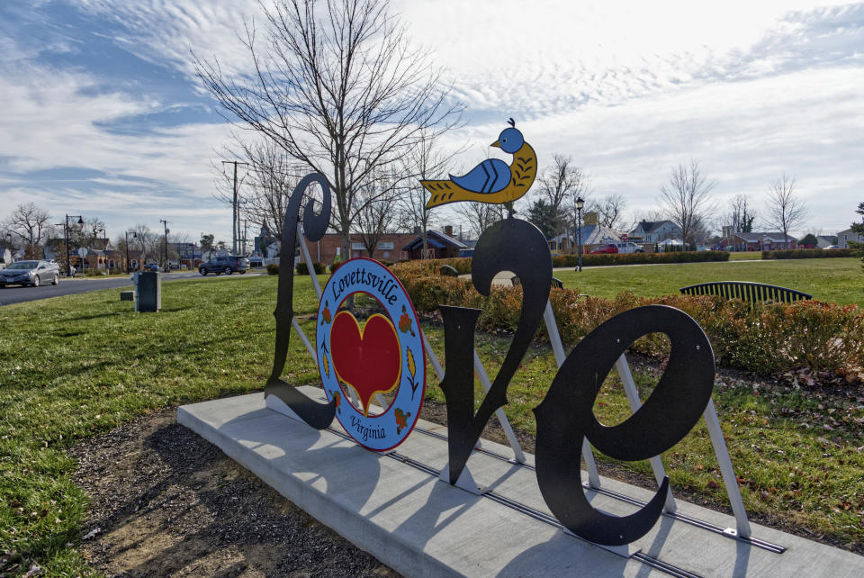 The 'Love' sign welcomes neighbors and passers-by on the rounded town square that they call the "Squirkle" in Lovettsville, Va.,on Dec. 24, 2021, In this town and others like it across the country, some wonder whether there's enough love to go around in a time of striking political division. In Lovettsville, that polarization coexists with a strong sense of community and a tradition of neighbor helping neighbor, regardless of politics. (AP Photo/Cal Woodward)