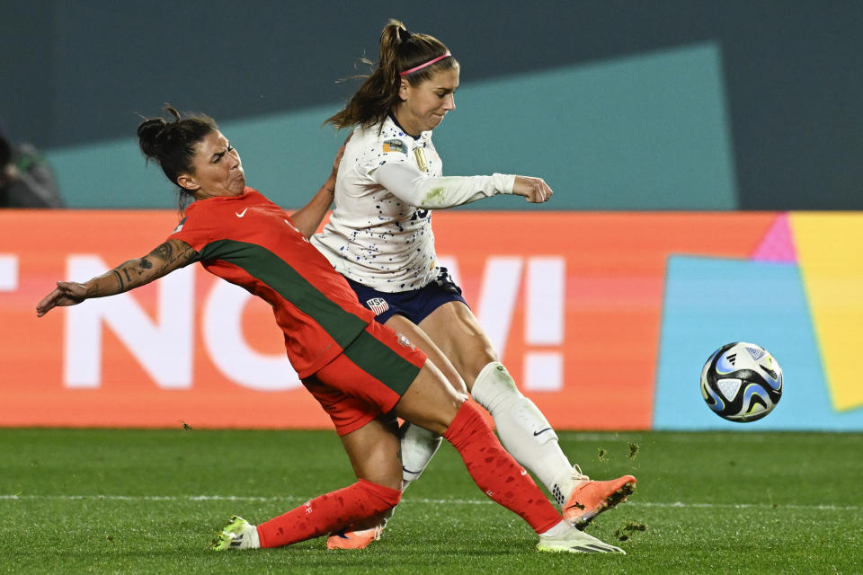 United States' Alex Morgan, right, attempts a shot as Portugal's Ana Borges blocks during the Women's World Cup Group E soccer match between Portugal and the United States at Eden Park in Auckland, New Zealand, Tuesday, Aug. 1, 2023. (AP Photo/Andrew Cornaga)