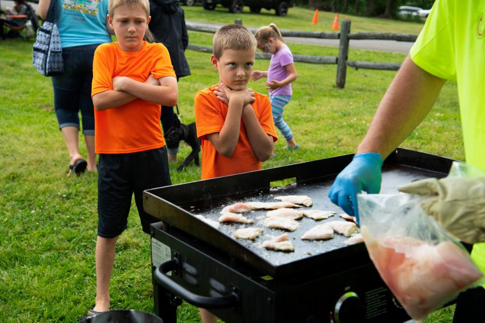 Silver carp fillets hit the griddle as skeptical would-be diners wait to sample the "delicacy" Saturday morning, May 4, 2019. Many river towns – hit hard by the loss of recreational fishing and water sports due to the invasive Asian carp – have found ways to capitalize on the fish by creating festivals like the Jumpfish Jamboree in Benton County, Tenn. Bowfishing tournaments, fish fries, carp education and amusement rides turn into money-making events like annual harvest festivals have for decades.