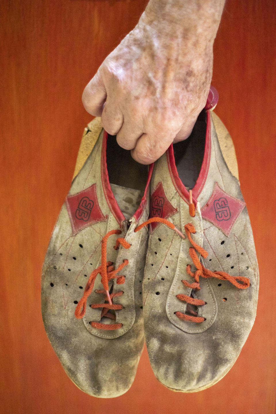 Israeli Olympic racewalker Shaul Ladany holds his 1972's Olympic race shoes for a portrait in Omer, Israel, Sunday, July 12, 2020. In an instant, the world record holder in the 50-mile walk was thrust into one of sports’ greatest tragedies and a seminal moment in modern history _ the kidnapping and massacre of his fellow Israeli team members at the 1972 Munich Olympics. The killing shocked the world, gave the Palestinian cause an audience and ushered in a new era of global terrorism. Ladany, a Holocaust survivor, the lessons still linger. He says it taught him to “never be afraid” but become “more careful.” AP Photo/Ariel Schalit)