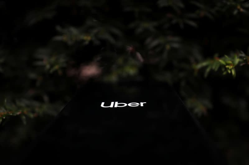 The Uber logo is displayed on a mobile phone in this picture illustration