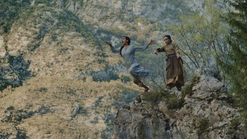 A shot of Egwene (Madeleine Madden) screaming in shock as Nynaeve (Zoe Robins) pushes her from a cliff’s edge into a river