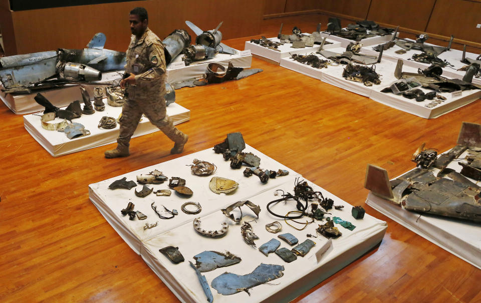 A Saudi military officer walks by what was described asa the remains of Iranian cruise missiles and drones used in an attack this weekend that targeted the heart of Saudi Arabia's oil industry, during a press conference by military spokesman Col. Turki al-Malki in Riyadh, Saudi Arabia, Wednesday, Sept. 18, 2019. Though Yemen's Houthi rebels claimed the assault, the U.S. alleges Iran was behind it. (AP Photo/Amr Nabil)