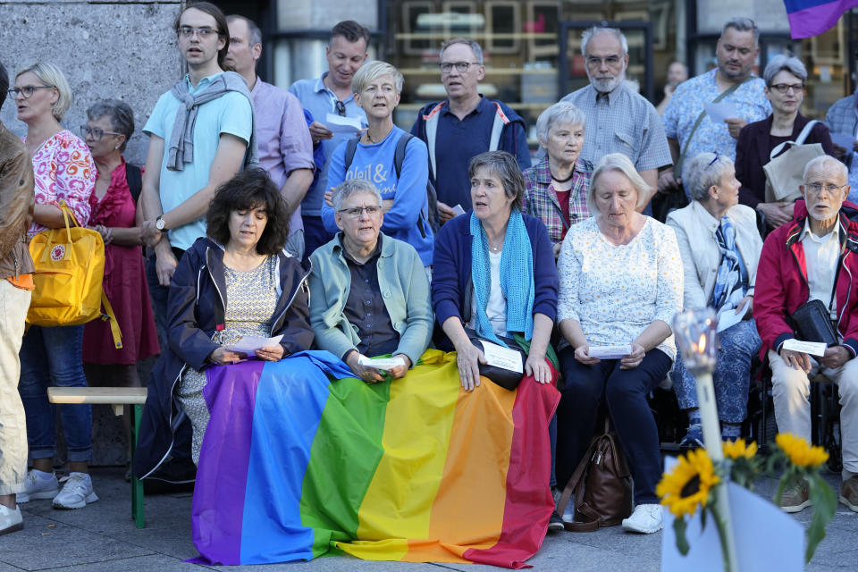 FILE - A public blessing ceremony with hundreds of believers take place in front of the Cologne Cathedral in Cologne, Germany, on Sept. 20, 2023. Pope Francis has formally approved allowing priests to bless same-sex couples, with a new document released Monday Dec. 18, 2023 explaining a radical change in Vatican policy by insisting that people seeking God’s love and mercy shouldn’t be subject to “an exhaustive moral analysis” to receive it. (AP Photo/Martin Meissner, File)