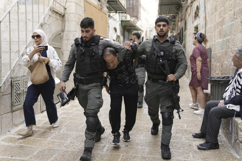 Israeli security forces detain a Palestinian activist in the Old City of Jerusalem, Monday, Oct. 2, 2023. Police tightened security measures in the area as thousands of Jewish worshippers gathered to mark the holiday of Sukkot. (AP Photo/Mahmoud Illean)