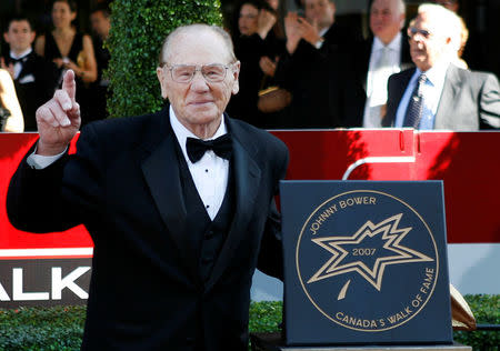FILE PHOTO: Former Canadian NHL goalie Johnny Bower stands by his star at the tenth annual Canada's Walk of Fame in Toronto, Ontario, Canada, June 9, 2007. REUTERS/Peter Jones/File Photo
