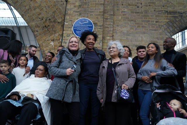 Relatives of Wilston Samuel Jackson stand below the plaque