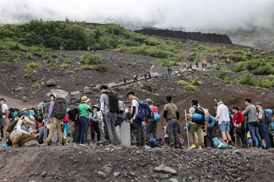 Visitors climb the slopes of Mount Fuji. With millions of visitors every year, Mount Fuji is no longer the peaceful, nature-filled pilgrimage site it once was.