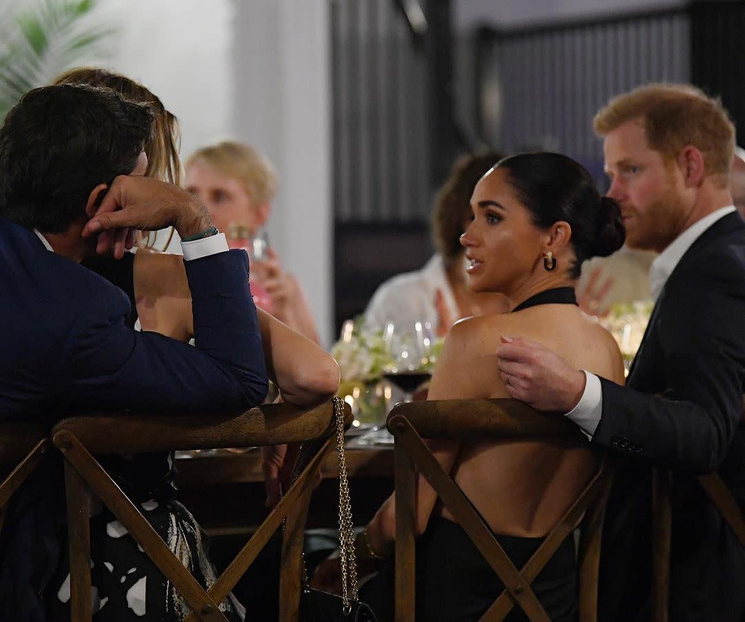 meghan brings the heat in a backless lbd