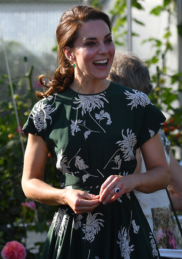 The Duchess looked stunning in an olive green Rochas dress dotted with white flowers. Getty