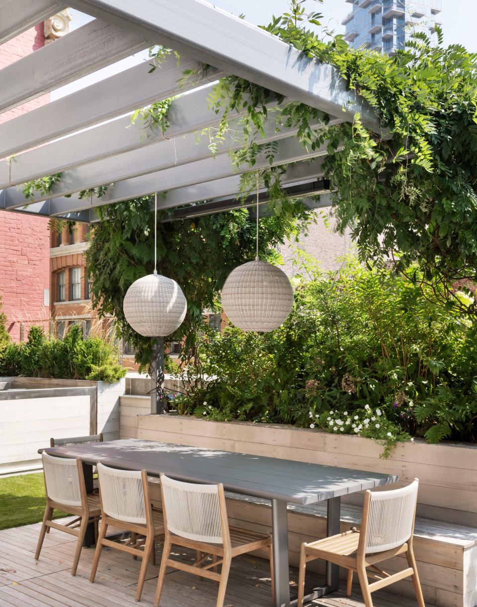 an outdoor dining space on a roof terrace