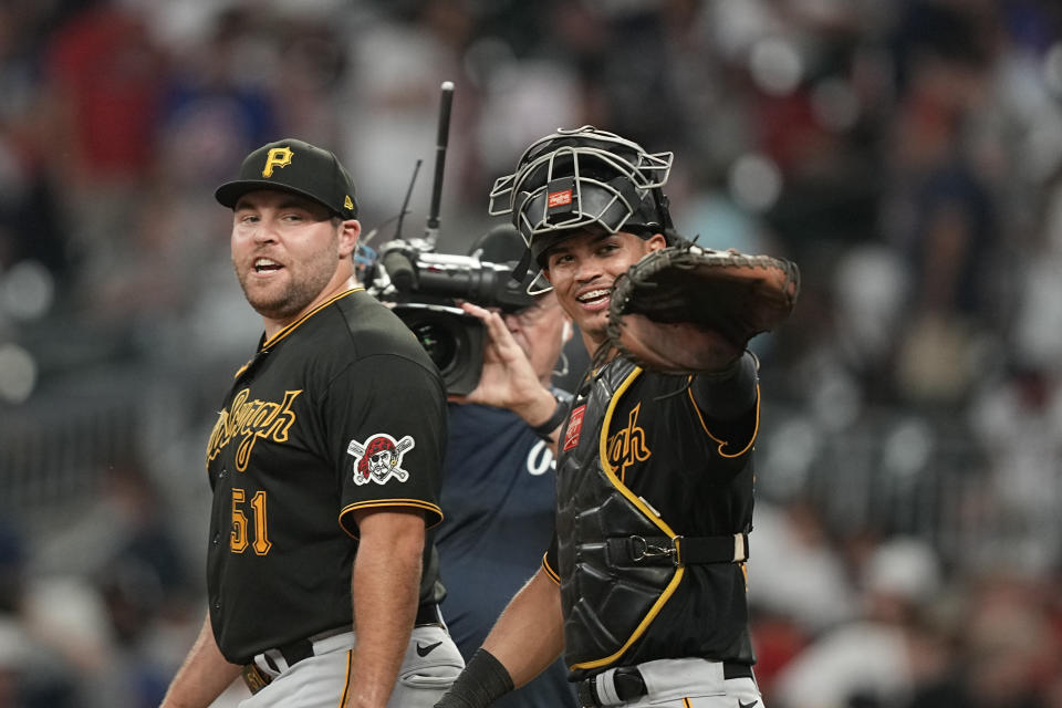 Pittsburgh Pirates relief pitcher David Bednar, left, and Pittsburgh Pirates catcher Endy Rodriguez, right, celebrate a win against the Atlanta Braves, Saturday, Sept. 9, 2023, in Atlanta. (AP Photo/Brynn Anderson)