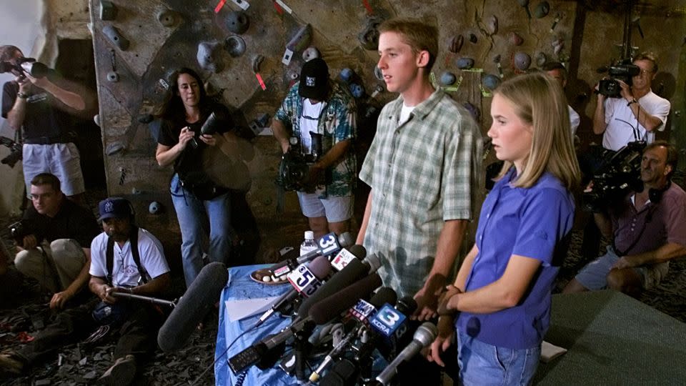 Tommy Caldwell, left, and Beth Rodden are surrounded by the media as they talk about their ordeal after they were taken captive, during a news conference held in Davis, California on August 24, 2000. - Rich Pedroncelli/AP