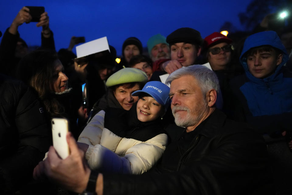 FILE - Presidential candidate and retired army Gen. Petr Pavel takes photos with his supporters during an election rally in Brno, Czech Republic, Jan. 20, 2023. Retired army Gen. Petr Pavel is challenging populist billionaire Andrej Babis in the Czech presidential runoff vote for the largely ceremonial post that pits the political newcomer against the former prime minister. (AP Photo/Petr David Josek, File)