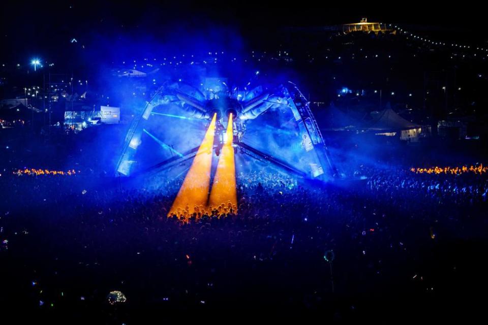 Thousands of revellers watch Groove Armada from beneath a 50-tonne laser spewing and fire breathing spider, at Arcadia