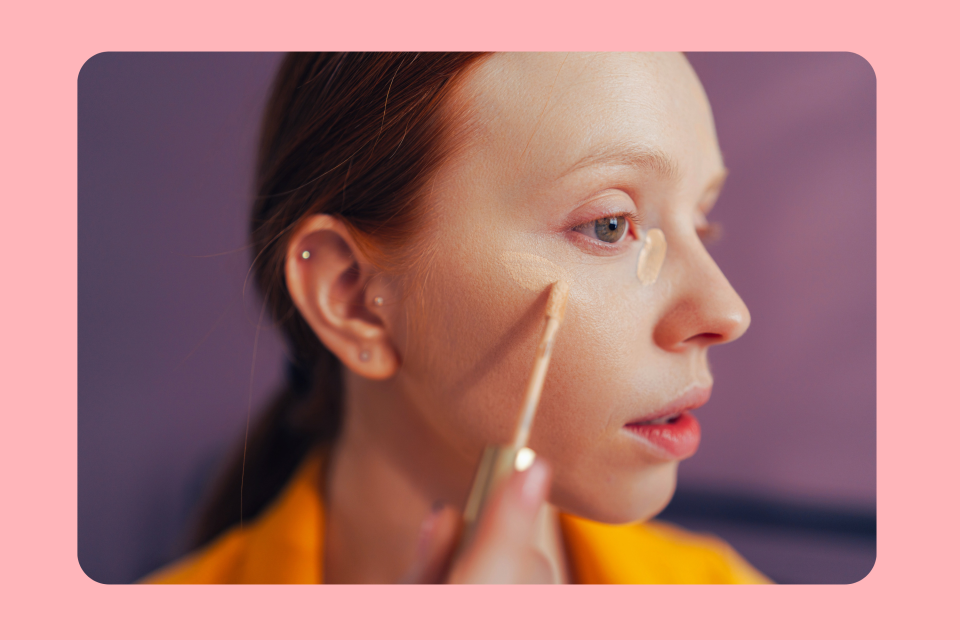 Woman applying concealer