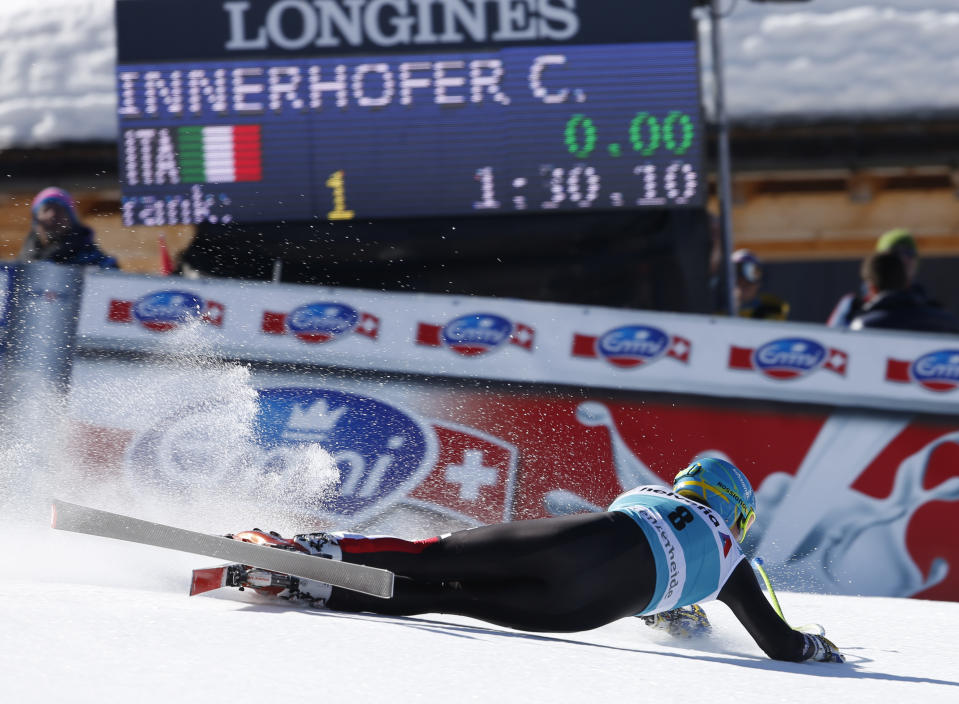 Italy's Christof Innerhofer falls at finish line after taking second place in a men's alpine skiing downhill at the World Cup finals in Lenzerheide, Switzerland, Wednesday, March 12, 2013. (AP Photo/Marco Trovati)