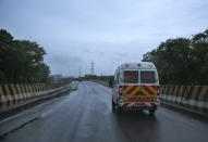 An ambulance rushes towards a hospital through a deserted flyover during a lockdown imposed to curb the spread of coronavirus in Kochi, Kerala state, India, Saturday, May 15, 2021. With cyclonic storm "Tauktae" intensifying over the Arabian Sea, the southern state has been receiving heavy rains. (AP Photo/R S Iyer)