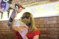 A member of staff at Solvay Society brewery in Leytonstone pours a beer on the first day of reopening after the lockdown due to the Coronavirus outbreak, in London, Saturday, July 4, 2020. England is embarking on perhaps its biggest lockdown easing yet as pubs and restaurants have the right to reopen for the first time in more than three months. In addition to the reopening of much of the hospitality sector, couples can tie the knot once again, while many of those who have had enough of their lockdown hair can finally get a trim. (AP Photo/Alberto Pezzali)