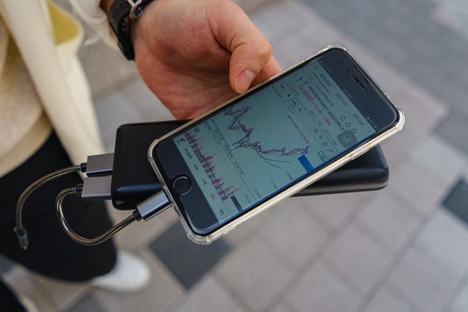 College student Jung Gyu-ho shows his stock portfolio through a smartphone app.