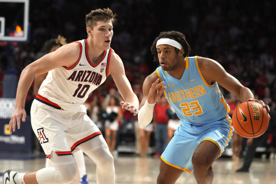 Southern University guard Bryson Etienne (23) drives against Arizona forward Azuolas Tubelis during the first half of an NCAA college basketball game, Friday, Nov. 11, 2022, in Tucson, Ariz. (AP Photo/Rick Scuteri)