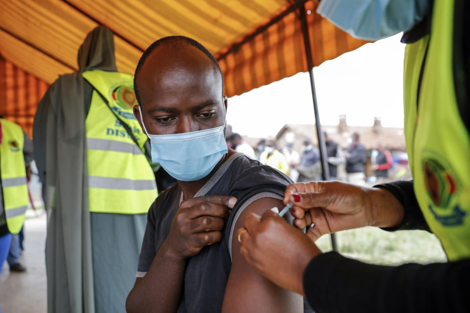 A Kenyan man receives a dose of AstraZeneca coronavirus vaccine donated by Britain, at the Makongeni Estate in Nairobi, Kenya Saturday, Aug. 14, 2021. In late June, the international system for sharing coronavirus vaccines sent about 530,000 doses to Britain – more than double the amount sent that month to the entire continent of Africa. It was the latest example of how a system that was supposed to guarantee low and middle-income countries vaccines is failing, leaving them at the mercy of haphazard donations from rich countries. (AP Photo/Brian Inganga)