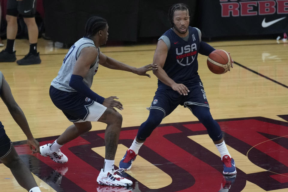 Jalen Brunson of the New York Knicks, right, drives up the court during training camp for the United States men's basketball team Friday, Aug. 4, 2023, in Las Vegas. (AP Photo/John Locher)