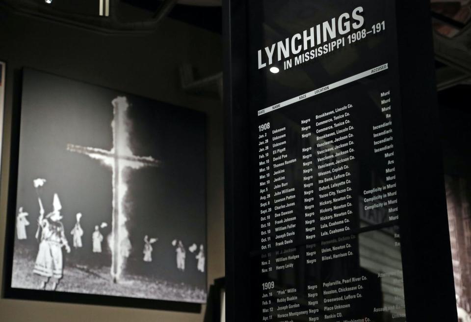 <span class="caption">A monolith listing the names, dates and rationale for the lynching of African Americans stands in front of a photograph of a burning Ku Klux Klan cross on display in the Mississippi Civil Rights Museum in Jackson, Miss.</span> <span class="attribution"><a class="link " href="http://www.apimages.com/metadata/Index/Mississippi-Bicentennial/c1d0082ab4424f97a6ac51c136f0ca2a/2/0" rel="nofollow noopener" target="_blank" data-ylk="slk:AP Photo/Rogelio V. Solis;elm:context_link;itc:0;sec:content-canvas">AP Photo/Rogelio V. Solis</a></span>