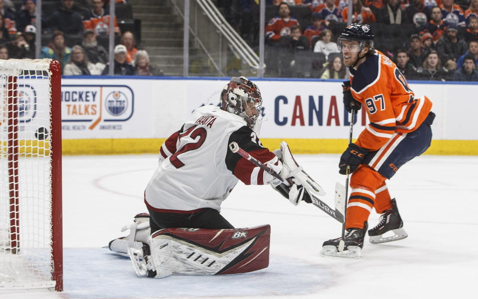 Arizona Coyotes goalie Antti Raanta (32) is scored on by Edmonton Oilers' Connor McDavid (97) during second period NHL action in Edmonton, Alberta, on Saturday, Jan. 18, 2020. (Jason Franson/The Canadian Press via AP)