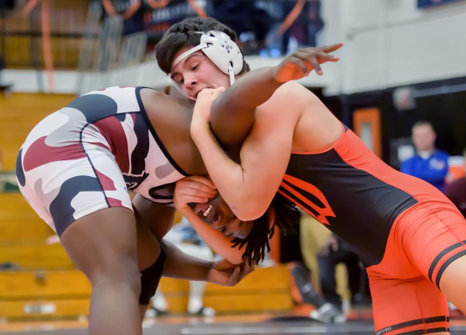 Washington's Josh Hoffer, right, puts a hold on Peoria High's Malachi Washington in the 195-pound match of the Class 2A wrestling regional Saturday, Feb. 4, 2023 at Washington Community High School. Hoffer took the win 7-2.