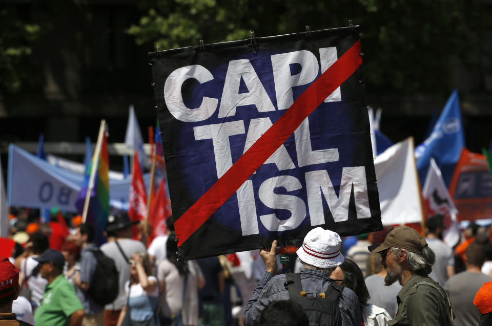 <p>A man holds a banner during a May Day rally on International Workers Day in Belgrade, Serbia, May 1, 2018. (Photo: Darko Vojinovic/AP) </p>