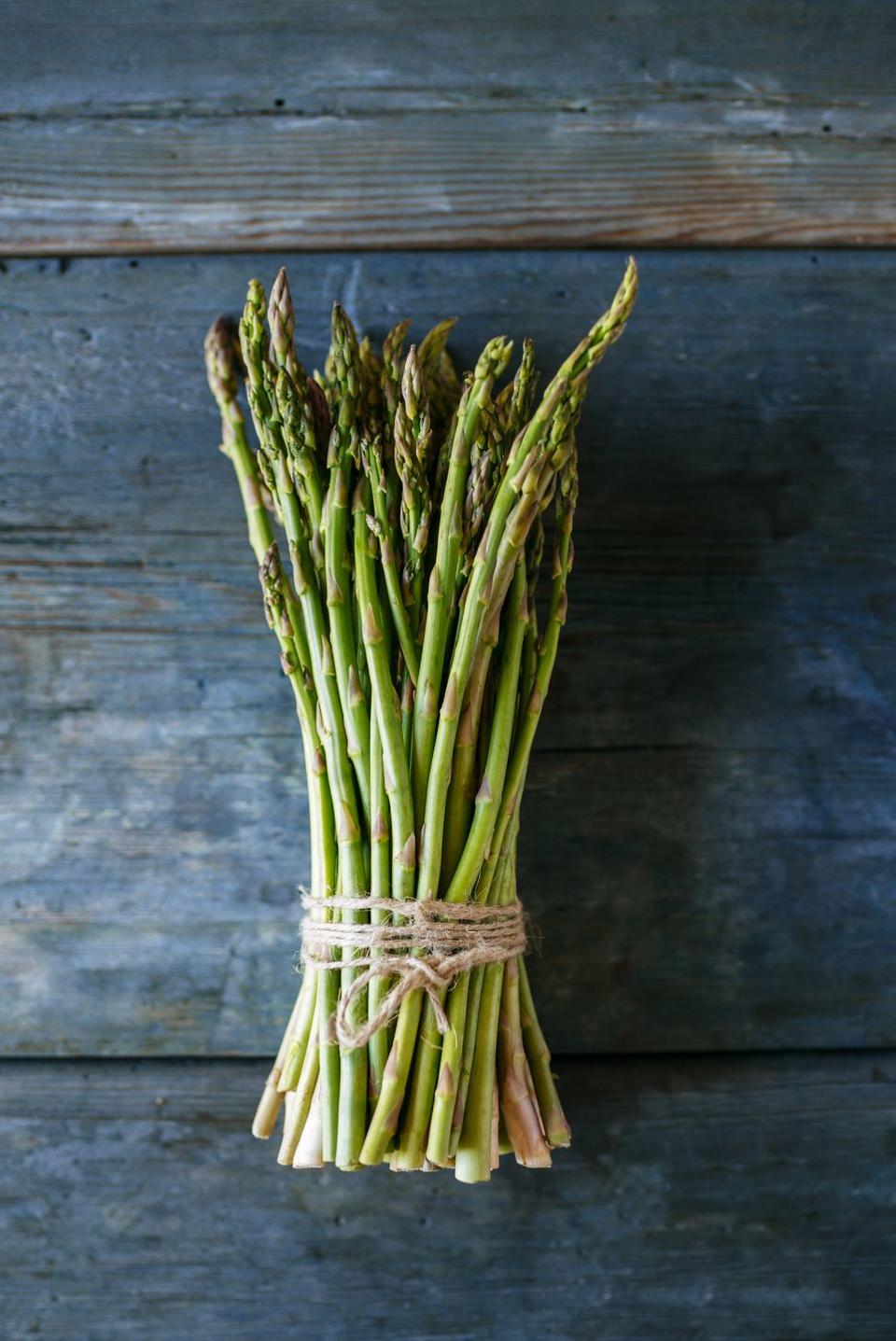 bunch of green asparagus on wood