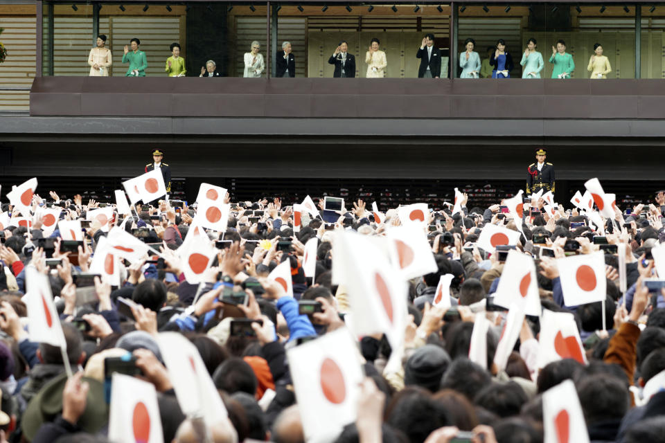 Japan's Emperor Naruhito, center left, waves with Empress Masako, center right, to well-wishers from the bullet-proofed balcony during a public appearance with his imperial families at Imperial Palace in Tokyo Thursday, Jan. 2, 2020, in Tokyo. (AP Photo/Eugene Hoshiko)