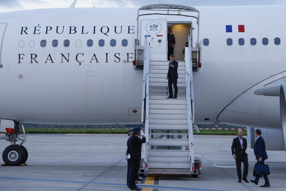 France's President Emmanuel Macron waves as he boards his Presidential plane to travel to the Pacific archipelago of New Caledonia, at the Orly airport, Paris Tuesday, May 21, 2024. (Ludovic Marin/Pool Photo via AP)