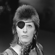 David Bowie with an eye patch and a mullet.
