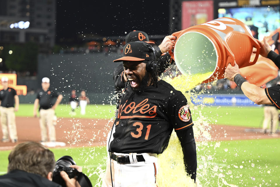 Baltimore Orioles' Cedric Mullins (31) is doused after the team defeated the Pittsburgh Pirates in a baseball game, Friday, May 12, 2023, in Baltimore. (AP Photo/Gail Burton)