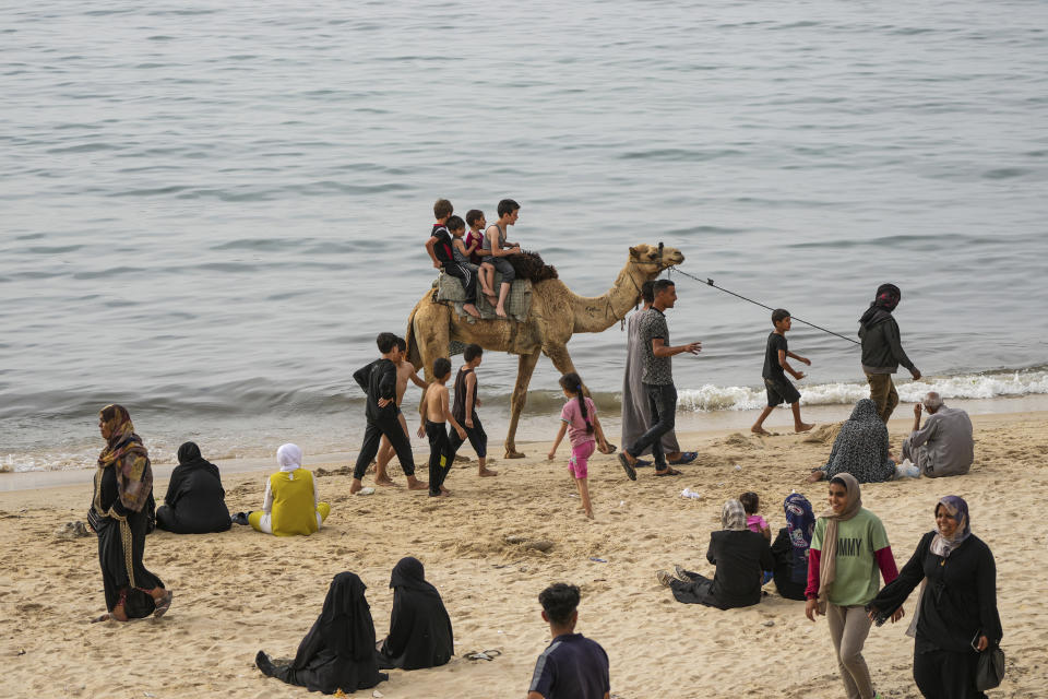 Palestinians who have been displaced by the ongoing war with Israel, spend the day on the beach along the Mediterranean Sea in Deir al Balah, Gaza Strip, April 25, 2024. (AP Photo/Abdel Kareem Hana)