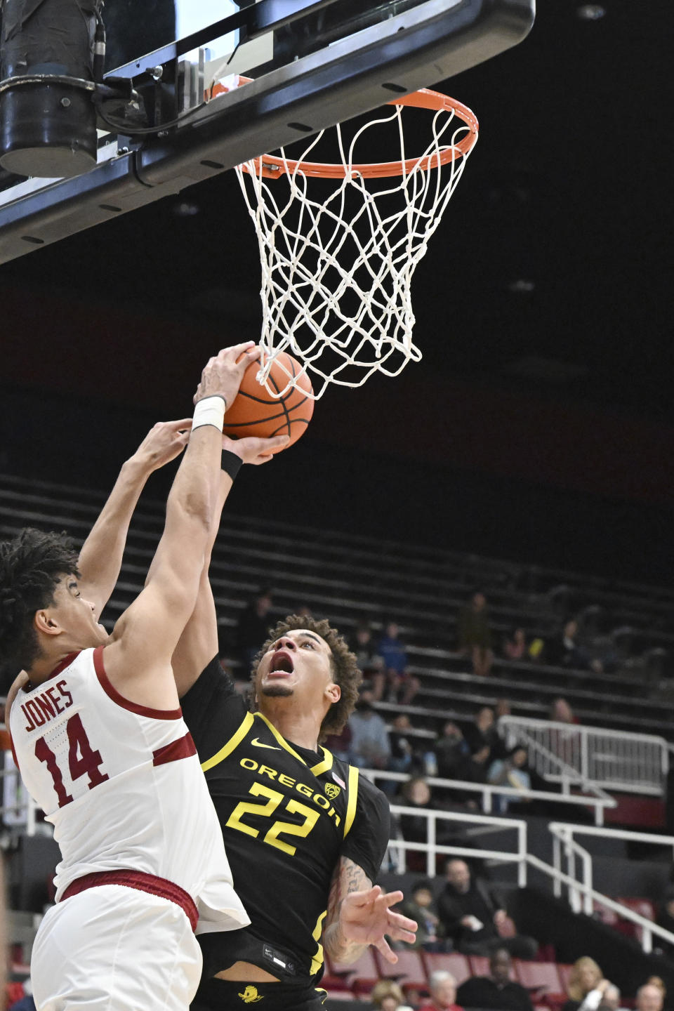 Stanford forward Spencer Jones (14) blocks a shot from Oregon guard Jadrian Tracey (22) during the second half of an NCAA college basketball game Thursday, Feb. 22, 2024, in Stanford, Calif. (AP Photo/Nic Coury)