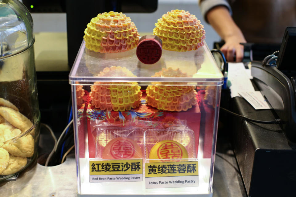 The classic red and yellow wedding biscuits (below) and the blossom biscuits (above) that are part of traditional customs in Chinese weddings and sold by Fung Wong. — Picture by Ahmad Zamzahuri