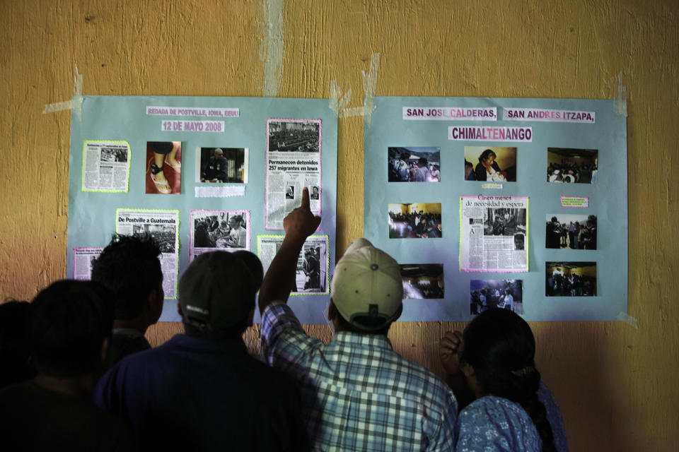 Guatemalans who were deported from the U.S. after a 2008 immigration raid in Postville, Iowa, and ended up in San Jose Calderas in Central Guatemala look at news clippings about the raid on May 12, 2009. (Photo: Daniel Leclair / Reuters)