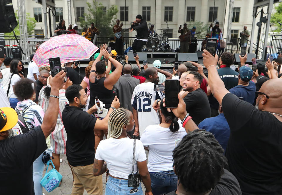 Attendees cluster around the stage while rapper KRS-One headlines the Wilmington Library Juneteenth Festival on Rodney Square Saturday, June 19, 2021.