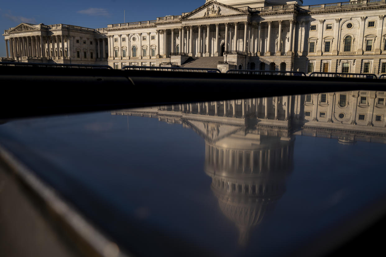 The dome of the U.S. Capitol is visible in a reflection in a pool on Capitol Hill.