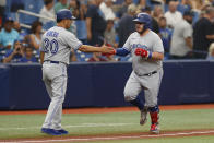Toronto Blue Jays' Alejandro Kirk, right, celebrates with third base coach Luis Rivera after hitting a home run against the Tampa Bay Rays during the second inning of a baseball game Sunday, Sept. 25, 2022, in St. Petersburg, Fla. (AP Photo/Scott Audette)